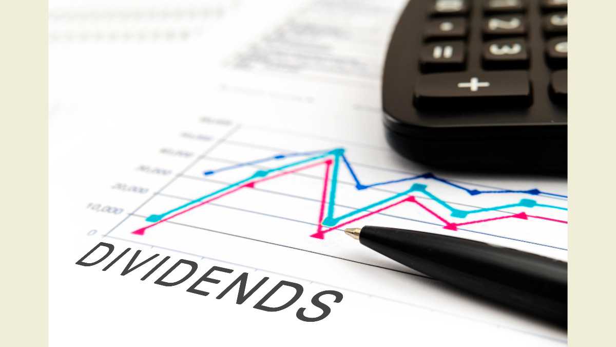 DIVIDENDS text on documents with graphs, charts, calculator, pen