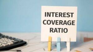 INTEREST COVERAGE RATIO text near financial reports and calculator. Financial concept.